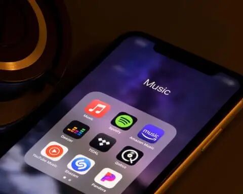 iphone with music streaming apps such as spotify and apple music in folder